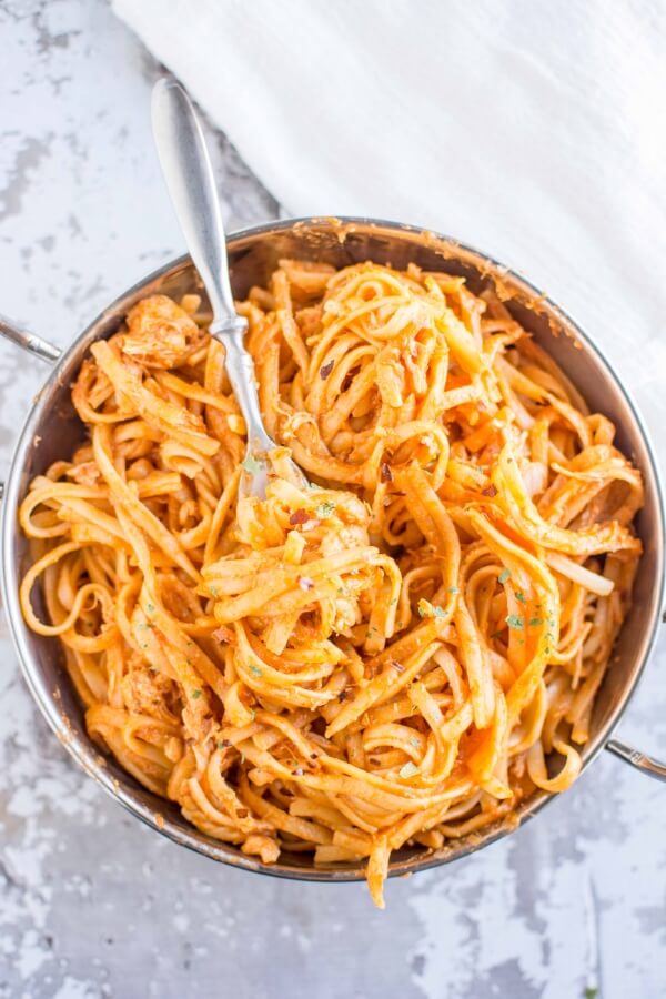 bowl filled with firecracker chicken pasta with fork