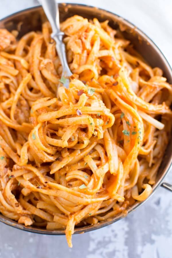 brown pan filled with firecracker chicken pasta with fork