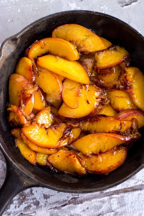 caramelized peaches in a cast iron skillet