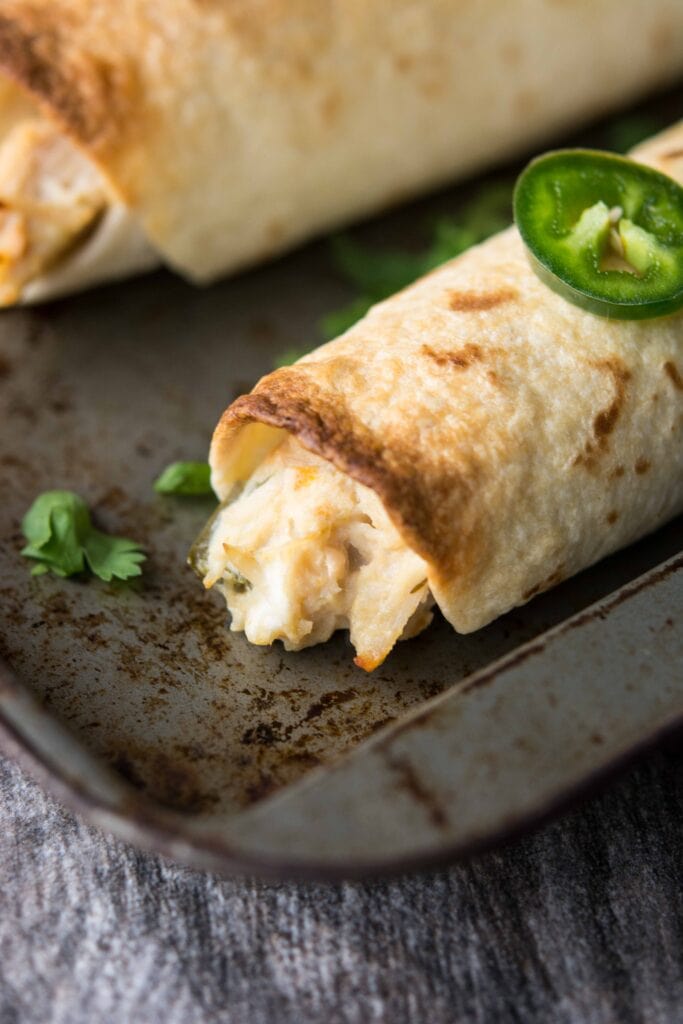 Up close image of Slow Cooker Jalapeno Popper Chicken Flautas filling.
