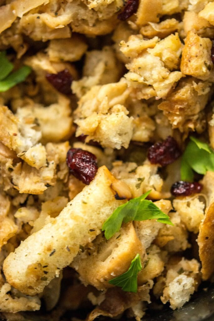 Close up view of Slow Cooker Stuffing with Caramelized Apple and dried cranberries
