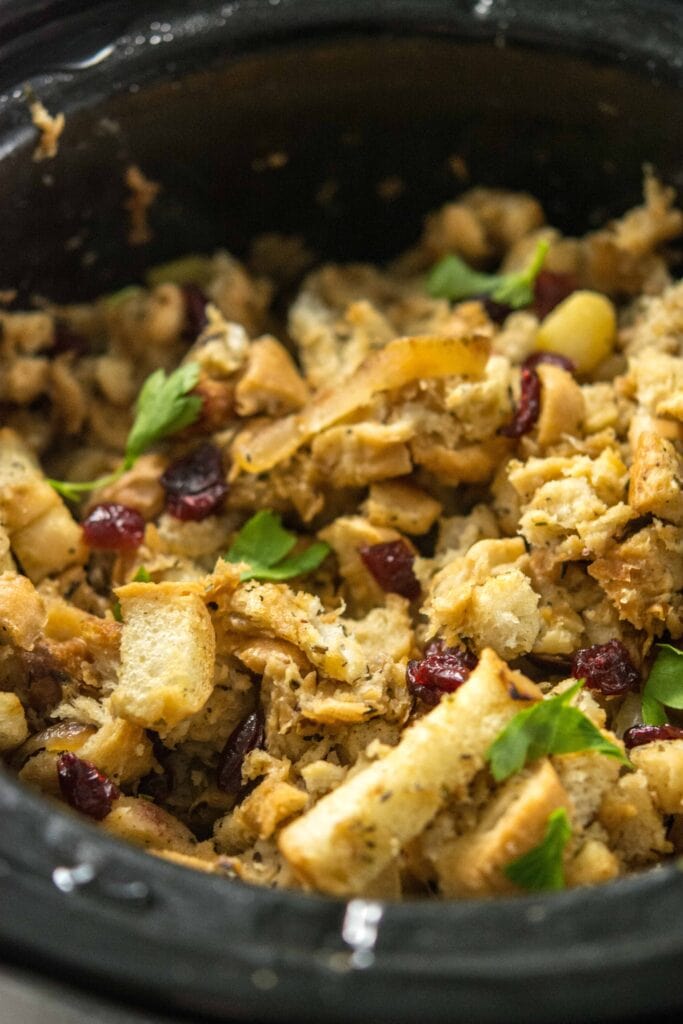 Slow Cooker Stuffing with Caramelized Apple and dried cranberries in round slow cooker