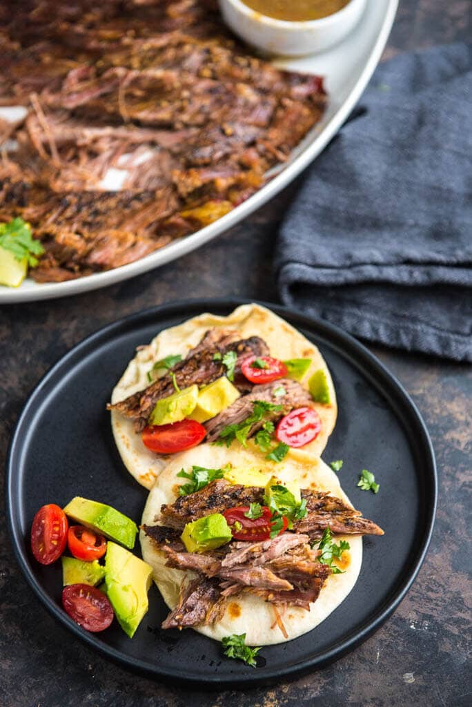 Slow Cooker Carne Asada is a simple way to make delicious tacos any night of the week! This tender delicious beef has just the right seasonings!
