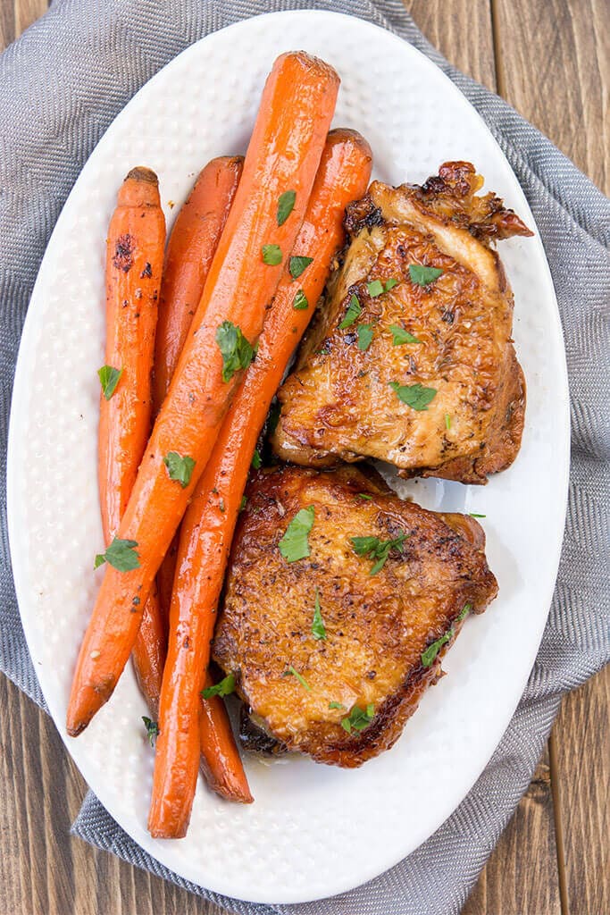 Two servings on a white plate - Slow Cooker Balsamic Chicken with Carrots sprinkled with cilantro