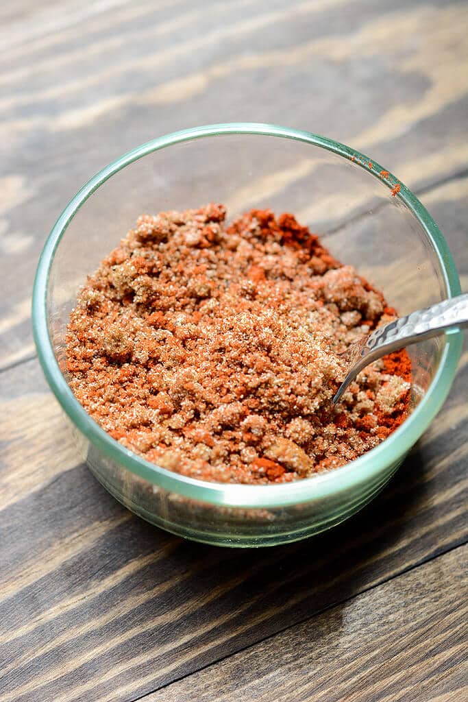 pork shoulder rubbed with spices in a slow cooker to make slow cooker pulled pork