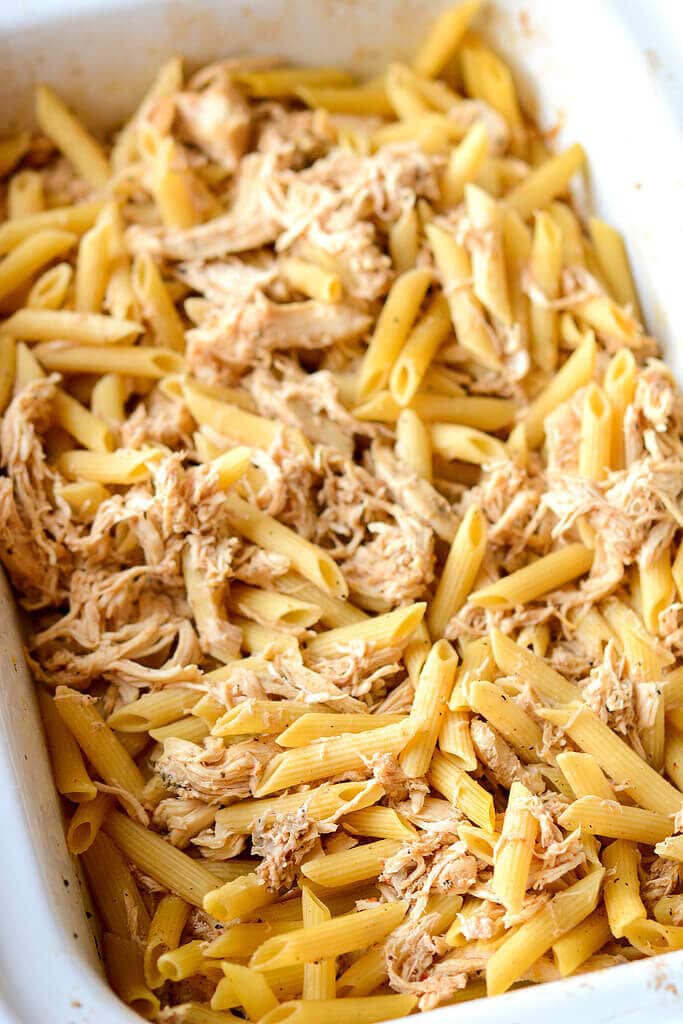 Pasta and chicken in a baking dish - Slow Cooker Chicken White Cheddar Bacon Mac