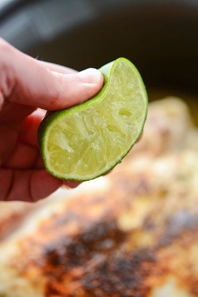 Squeezing fresh lime over chicken - Slow Cooker Tequila Lime Chicken