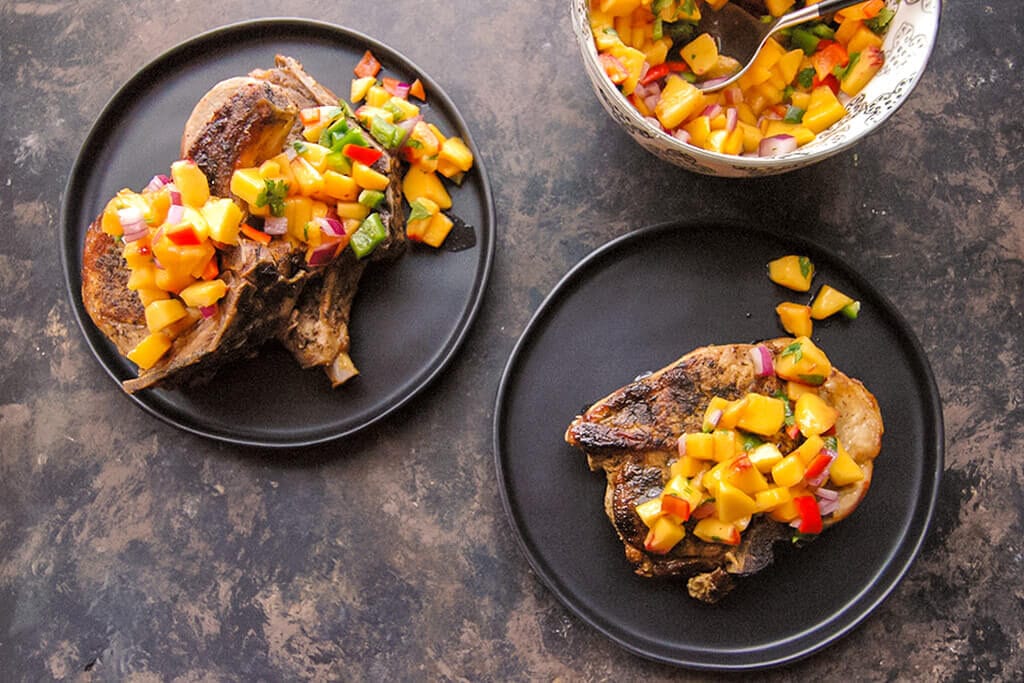 These bone in pork chops are easy to make in your slow cooker and you wouldn't believe how simple it is to make the healthy peach salsa! 
