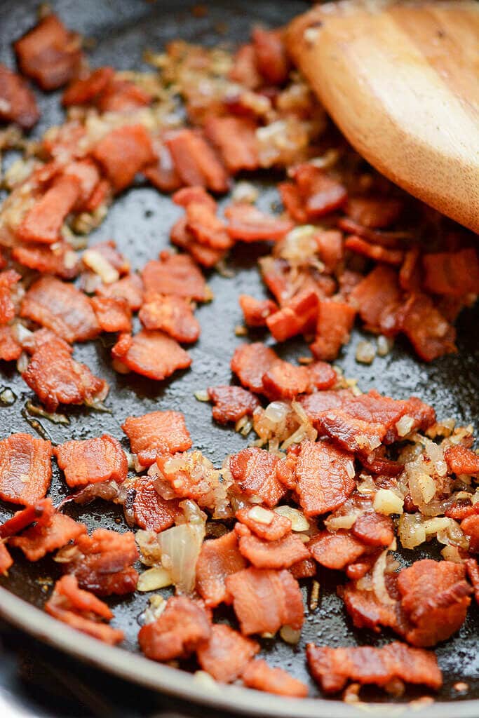 Slow Cooker Artichoke Dip - Bacon cooking in a skillet