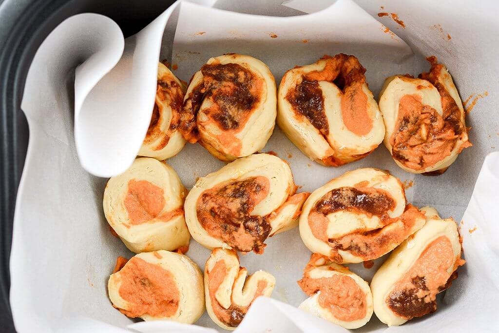 Placing Rolls in Slow Cooker - Slow Cooker Pumpkin Cinnamon Rolls