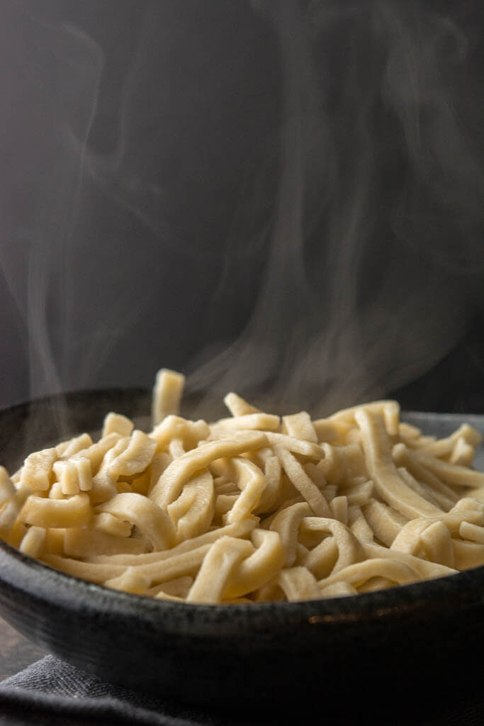 egg noodles steaming in a bowl