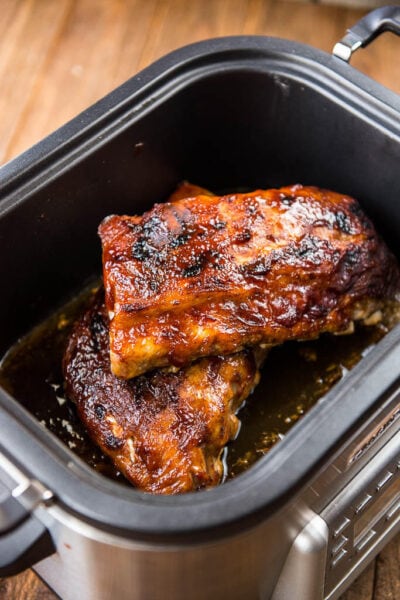 Slow Cooker BBQ Ribs are the answer to all your summertime meal needs! Whether entertaining or just creating a delicious family dinner you won't be disappointed with these fall-off-the-bone tender ribs!