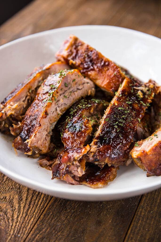 Slow Cooker BBQ Ribs are the answer to all your summertime meal needs! Whether entertaining or just creating a delicious family dinner you won't be disappointed with these fall-off-the-bone tender ribs!