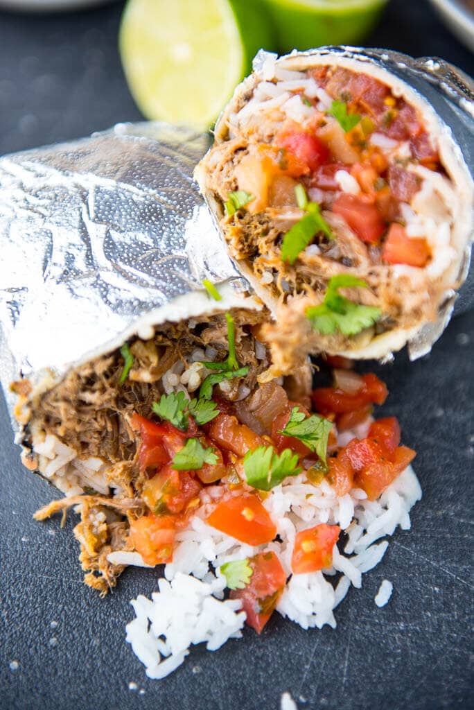 Slow Cooker Barbacoa Burritos are the easy alternative to take-out. A perfect summer family meal all wrapped up!