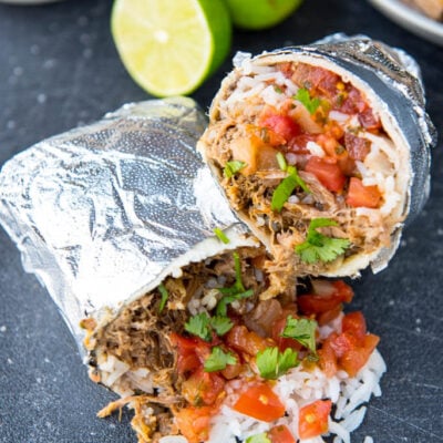 Slow Cooker Barbacoa Burritos are the easy alternative to take-out. A perfect summer family meal all wrapped up!