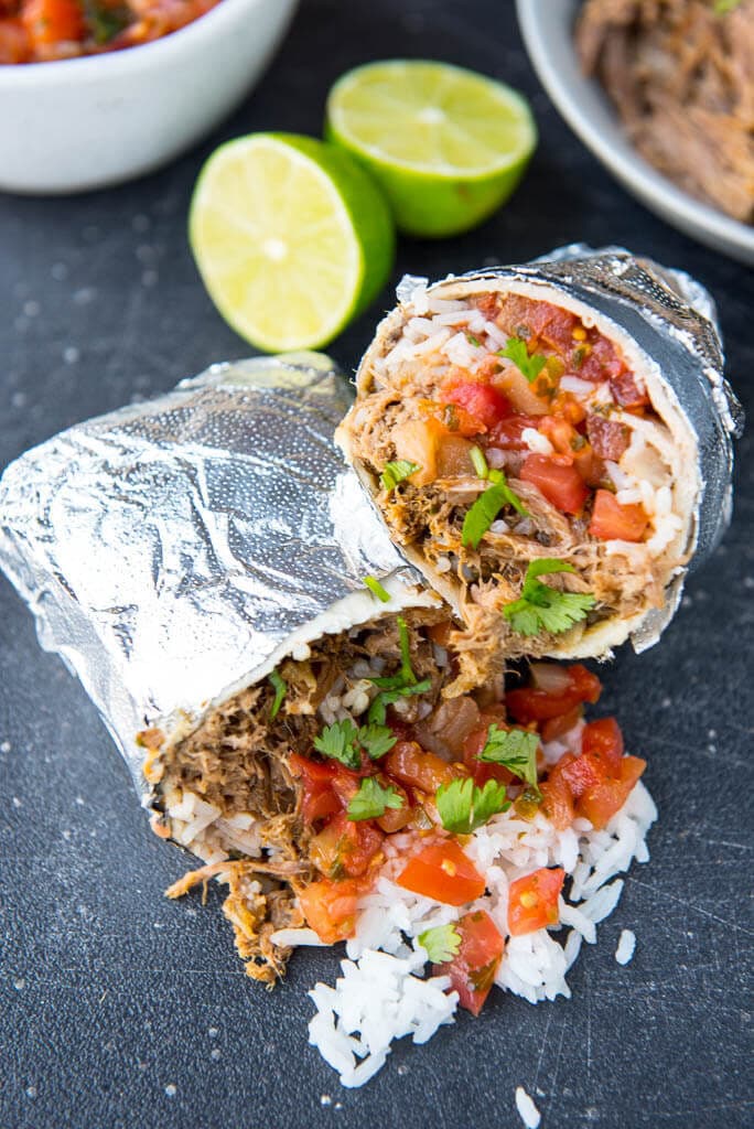 Slow Cooker Barbacoa Burritos are the easy alternative to take-out. A perfect summer family meal all wrapped up!