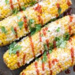 This simple Mexican Corn on the Cob with Sriracha and Cilantro Lime Butter is the perfect simple side dish to go with all your favorite Food Truck Friday main dish creations!