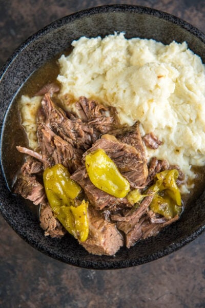 Slow Cooker Mississippi Pot Roast is a simple way to take your dinner from average to amazing! Mezzetta Pepperoncini Peppers give a tasty twist to roast beef for the ultimate family meal.
