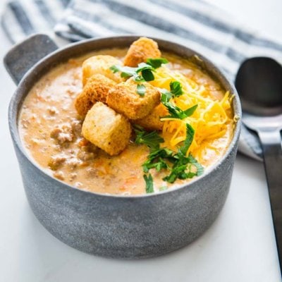 Slow Cooker Cheeseburger Soup in a metal bowl topped with croutons