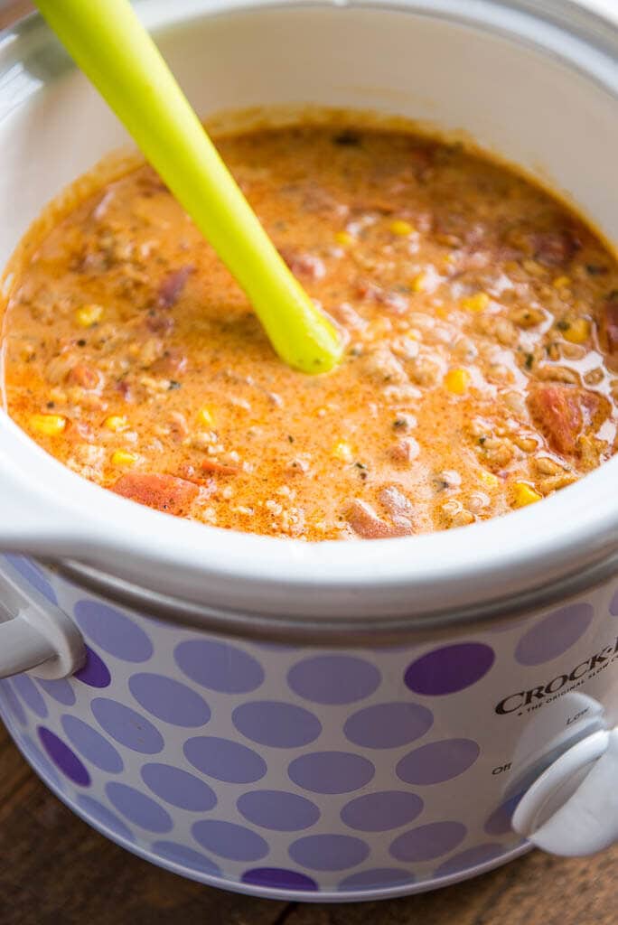 buffalo chicken chili in purple dotted crock with yellow spoon