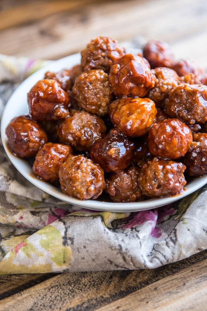 Slow Cooker Grape Jelly Meatballs in a gray bowl on the table