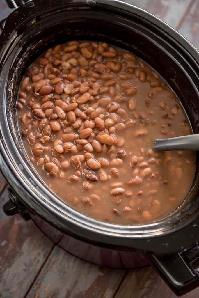 Slow Cooker Pinto Beans in purple and black slow cooker
