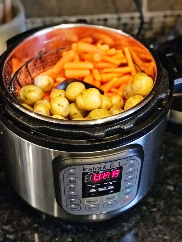 potatoes and carrots on steamer basket in Instant Pot