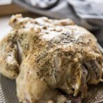 Instant Pot Whole Chicken with seasonings on baking sheet ready to shred