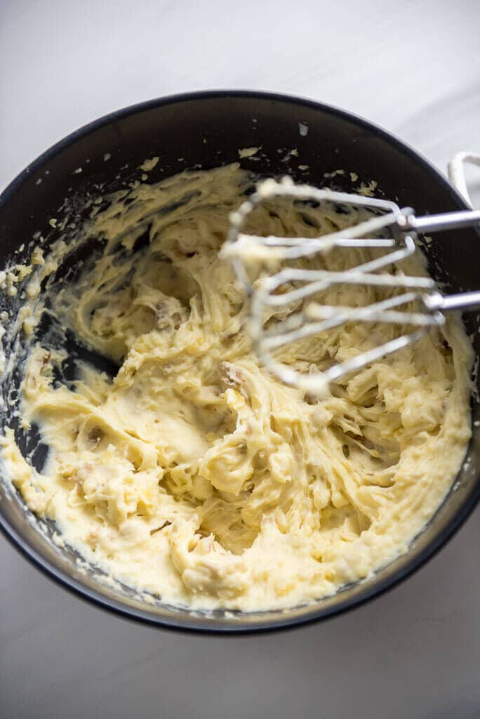 Freshly whipped Buttermilk Mashed Potatoes in a black mixing bowl. 
