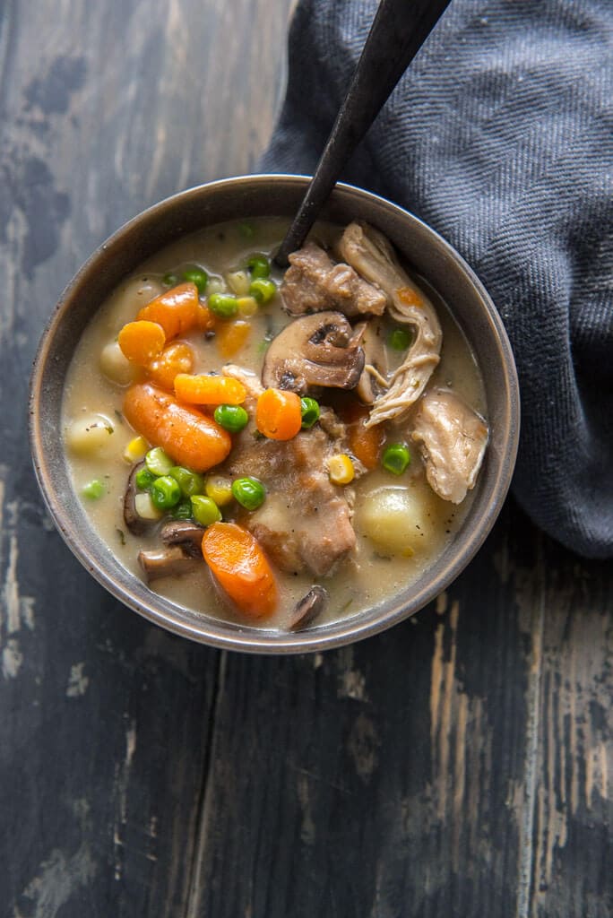 instant pot chicken and dumplings with veggie in gray bowl on black table