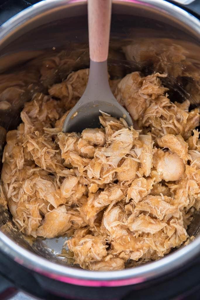 Mongolian chicken in instant pot with serving spoon