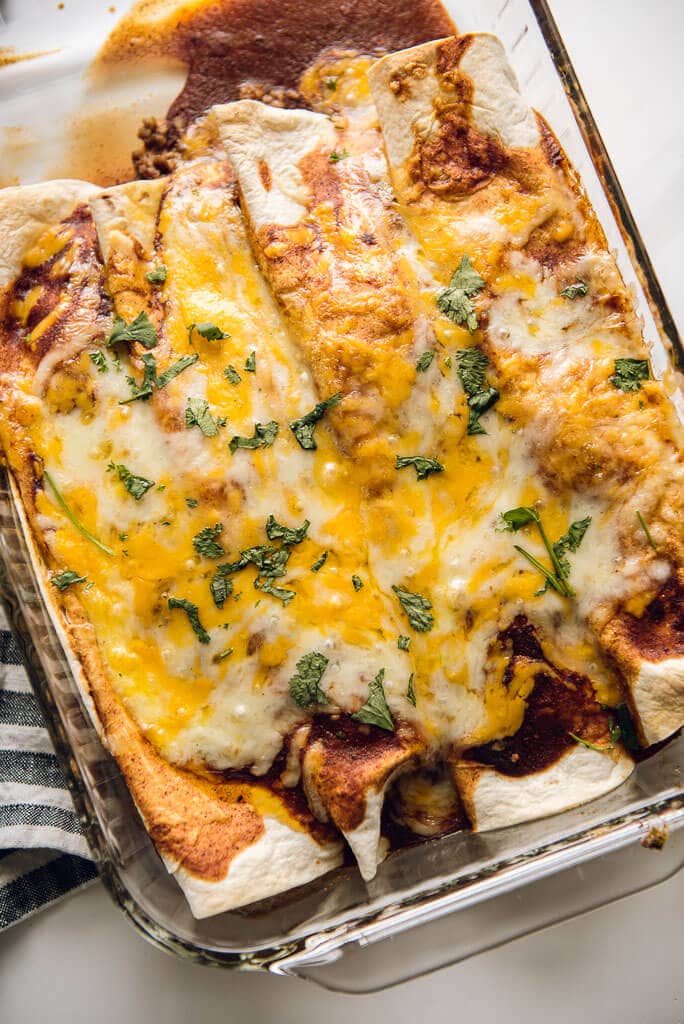 Easy Beef Enchiladas from the oven in a glass casserole dish