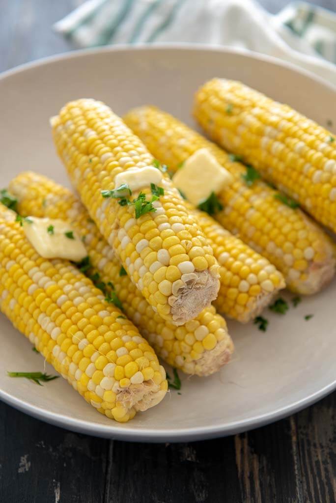 corn on the cob from the instant pot in a white bowl