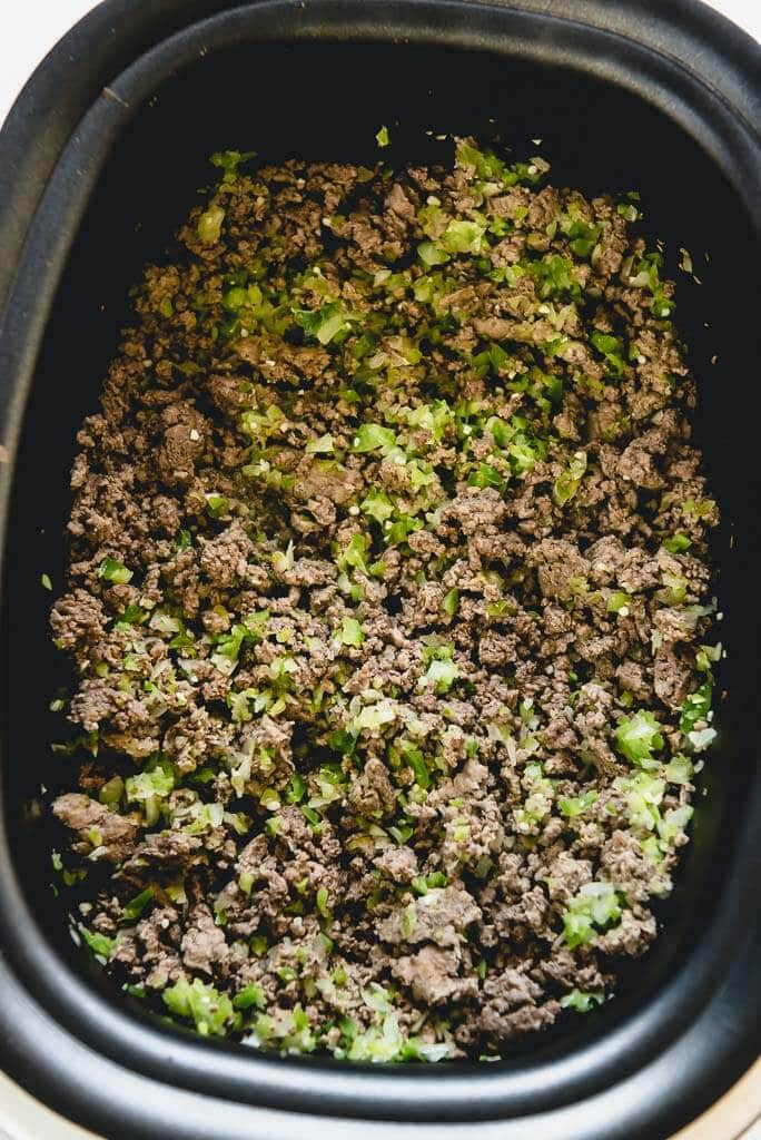 cooked beef, peppers and onions ready to add sloppy Joe sauce in the slow cooker