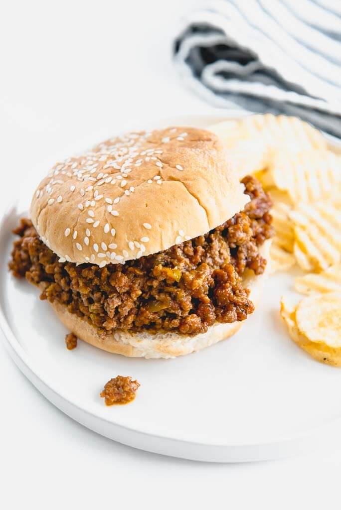 slow cooker sloppy Joe on white plate with chips