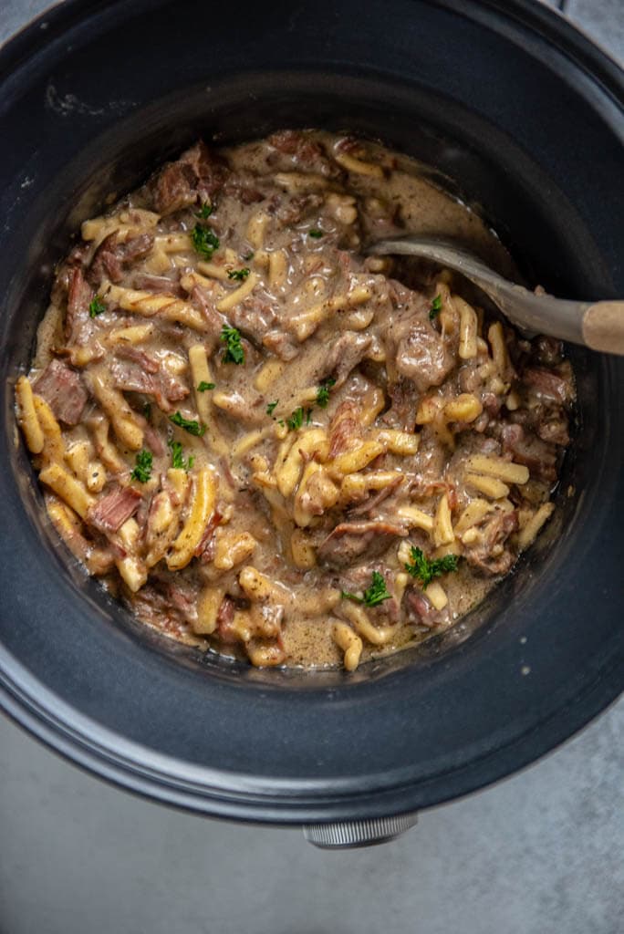 beef and noodles in a round slow cooker