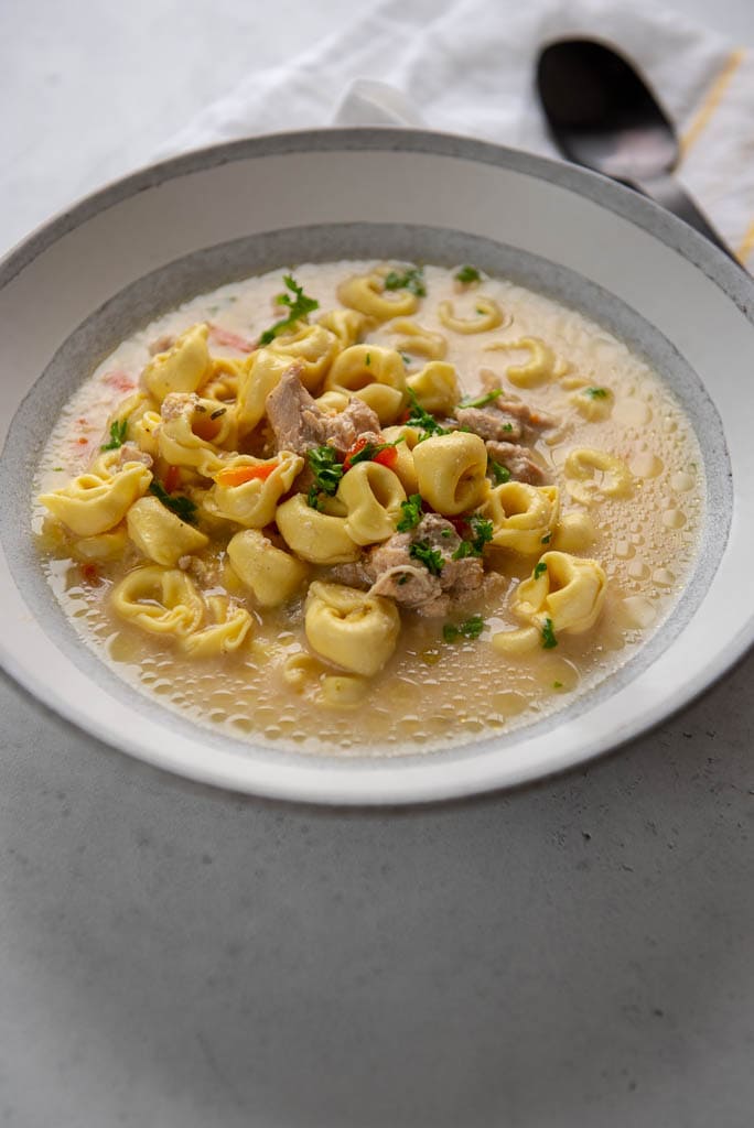 chicken tortellini soup in gray bowl