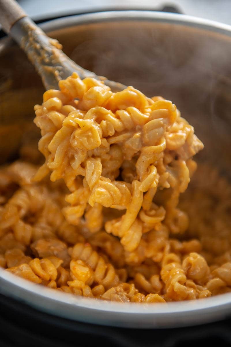 buffalo chicken pasta being scooped out of instant pot