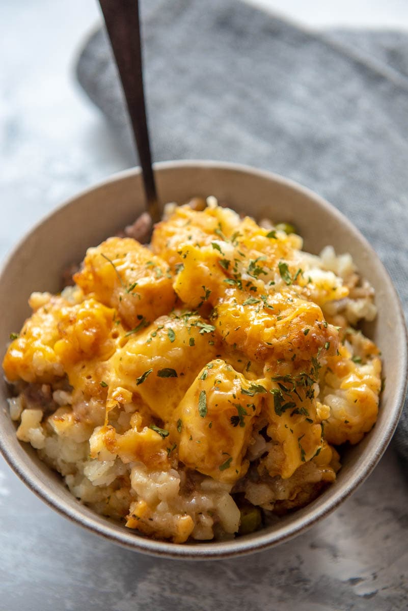 tater tot casserole with melted cheese in bowl