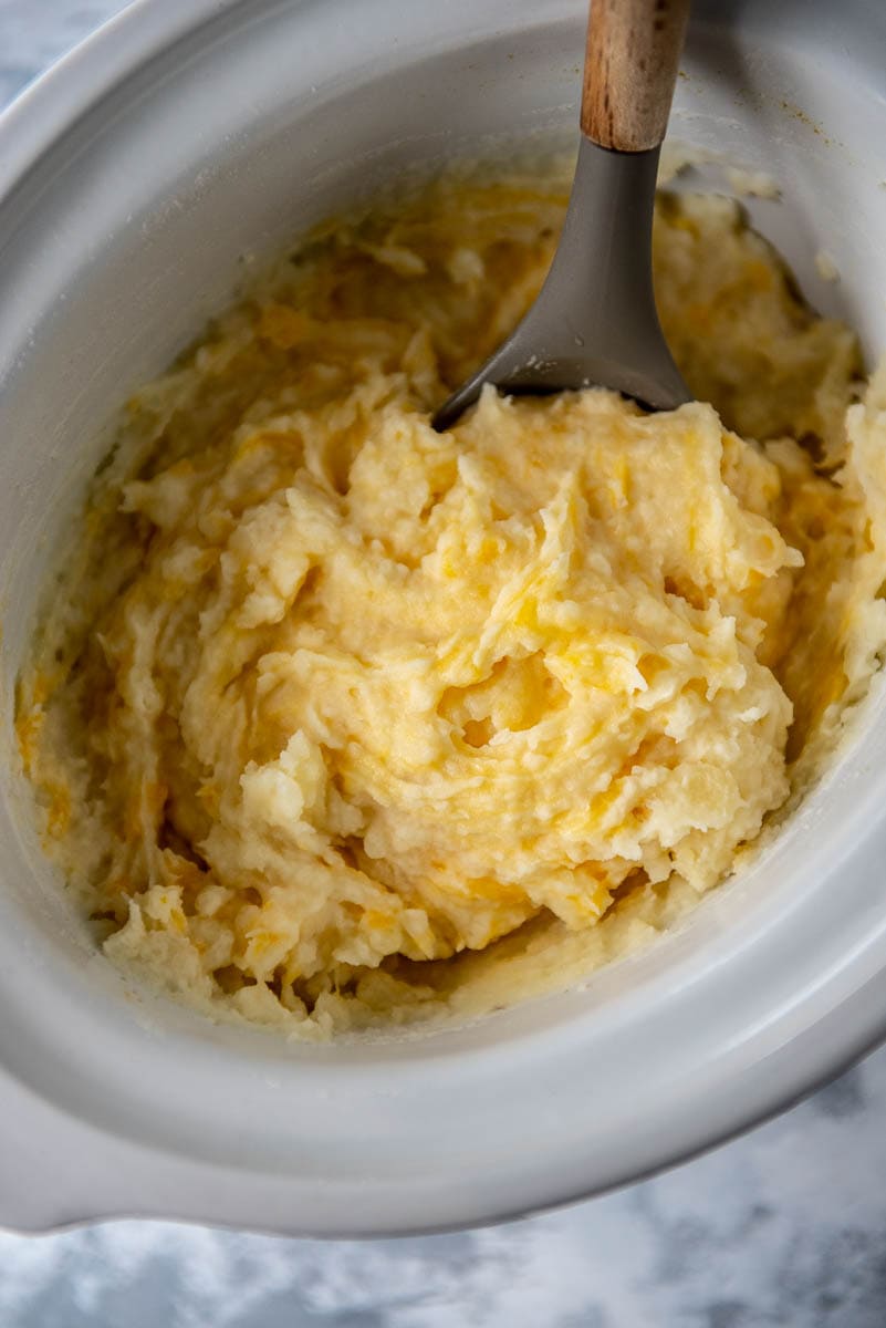 cheesy mashed potatoes in a slow cooker