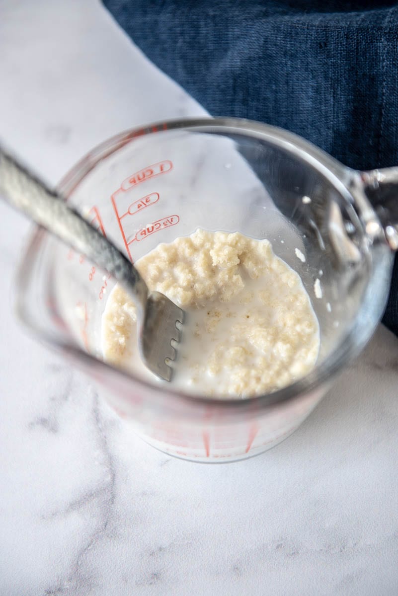 measuring cup with soaked breadcrumbs