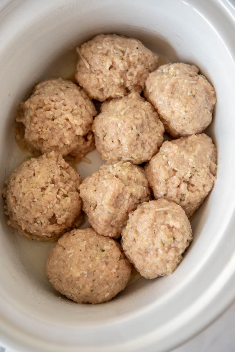 slow cooker full of chicken meatballs ready to cook