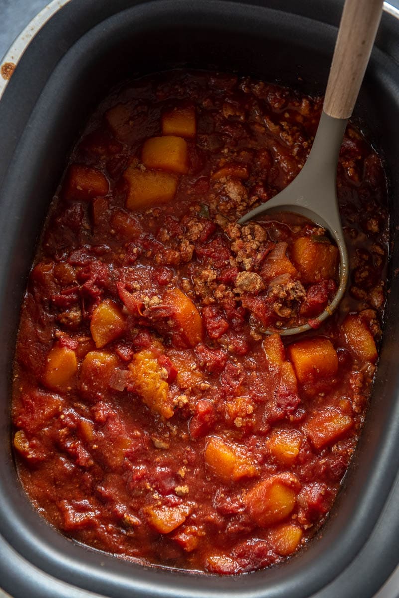 turkey chili with butternut squash and ladle in rectangle slow cooker