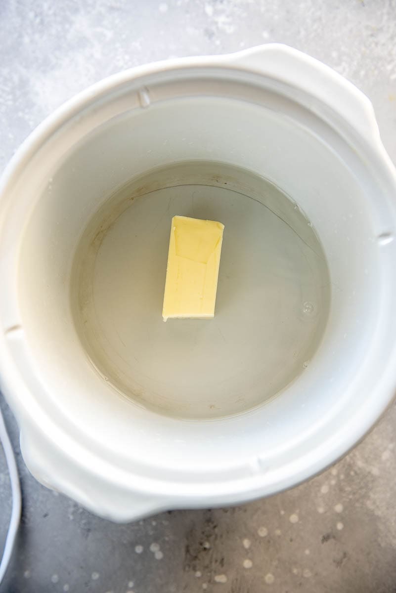 water and stick of butter in slow cooker
