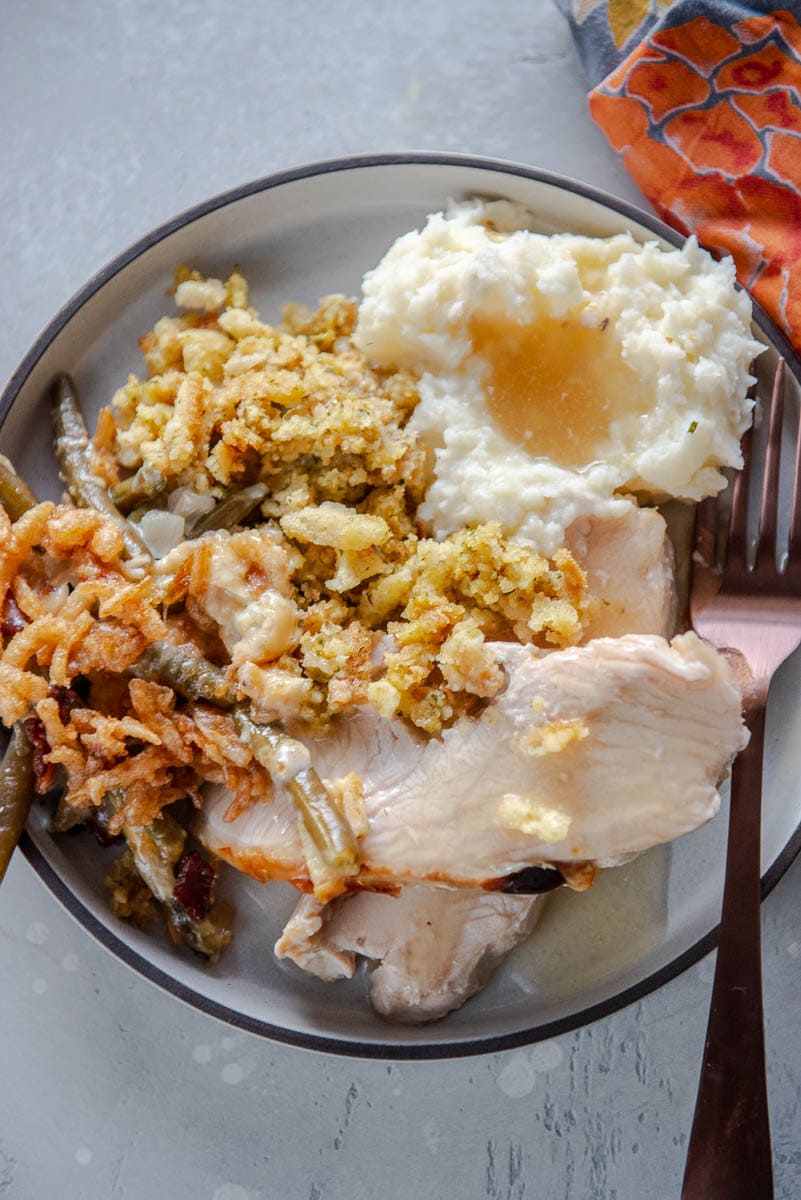 turkey, stuffing and mashed potatoes on gray plate