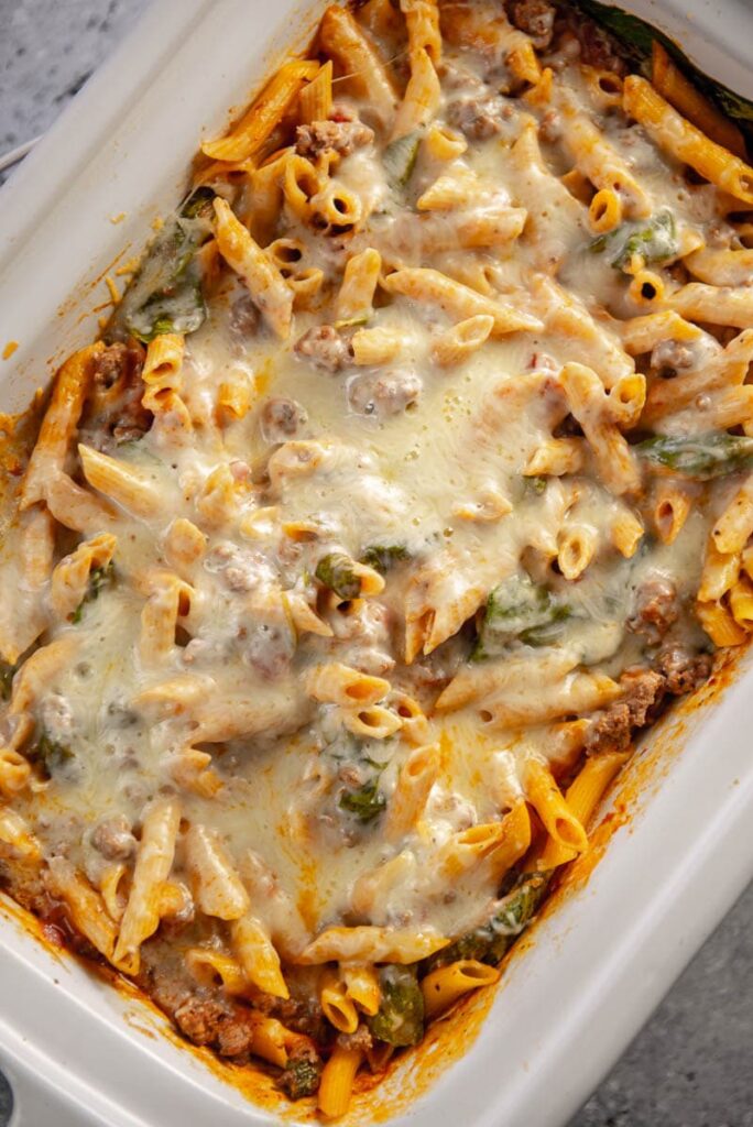pasta bake with melted cheese in casserole slow cooker