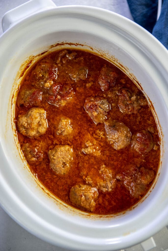 pork meatballs with sauce in a white casserole slow cooker
