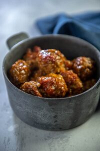 pork meatballs in a gray metal serving bowl