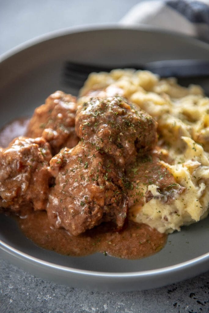gluten free meatballs in gray bowl with dairy free mashed potateos