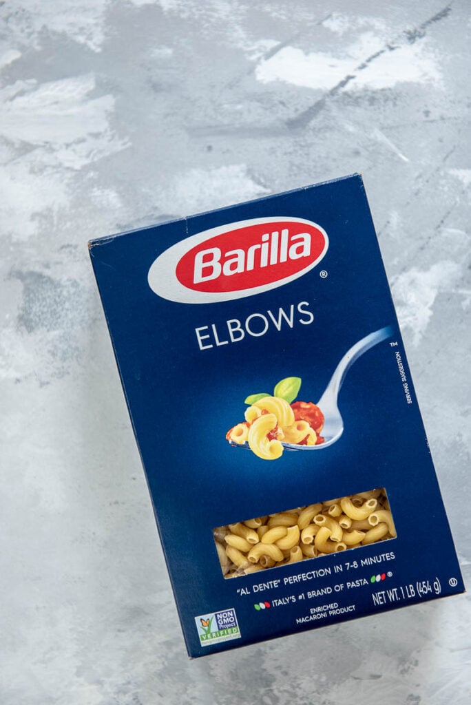 box of Barilla elbow pasta, can of tomatoes, and can of tomato sauce